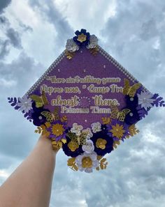 a purple and gold graduation cap with words on it