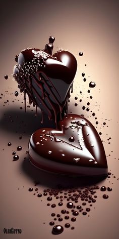 two chocolate hearts are melting on top of each other, with drops of water around them