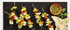 several skewers of food sitting on top of a cutting board