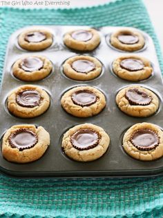 chocolate covered cookies in a muffin tin on a blue towel