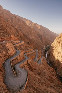 an aerial view of a winding road in the mountains