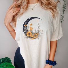 This Floral Crescent Moon Shirt is a soft-washed, garment-dyed fabric brings extra coziness to your wardrobe while the relaxed fit makes it an excellent daily choice. The double-needle stitching throughout the tee makes it highly durable while the lack of side-seams helps the shirt retain its tubular shape. .: 100% ring-spun cotton .: Medium fabric (6.1 oz/yd² (206.8 g/m .: Relaxed fit .: Sewn-in twill label Trendy Cotton T-shirt With Moon Print, Casual Cotton T-shirt With Moon Print, Casual Relaxed Fit T-shirt With Moon Print, Casual Floral Print Loungewear Shirt, Casual Floral Print Shirt For Loungewear, Cotton Crew Neck Top With Moon Print, Relaxed Fit Graphic Tee With Moon Print, Trendy Spring Tops With Moon Print, Cotton Summer Tops With Moon Print