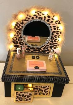 an animal print vanity with lights on it and a mirror in the middle that is lit up