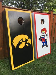 two cornhole game boards sitting in the grass