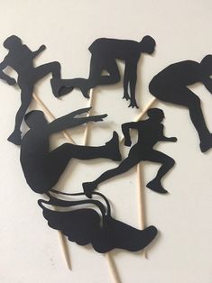 the cake toppers are made to look like silhouettes of people doing different things