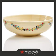 the bowl is decorated with colorful flowers and beads on it's rim, which matches the rest of the bowl