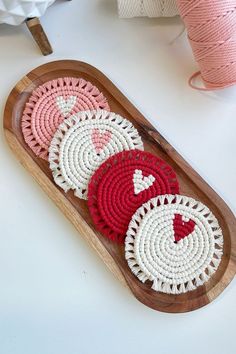 a wooden tray with crochet designs on it