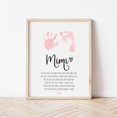 a pink hand and foot print with the words mumy on it