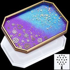 a purple and blue tray with gold trimmings on it, sitting on top of a white plate