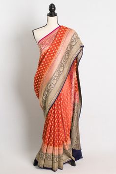 Silk Mark Certified Khaddi Georgette Banarasi Saree in Orange. Traditional Orange Georgette Pre-draped Saree, Orange Traditional Drape Blouse Piece For Ceremonies, Traditional Handloom Georgette Saree, Georgette Pre-draped Saree With Zari Weaving For Festivals, Traditional Georgette Wear With Zari Weaving For Festivals, Festive Georgette Pre-draped Saree With Zari Weaving, Handloom Georgette Saree For Festivals, Festive Handloom Georgette Saree, Traditional Orange Pre-draped Georgette Saree