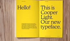 an open book with the words hello and this is cooper light our new typeface