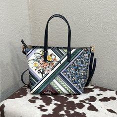 Gently Used, Tory Burch Floral Handbag.The Bag Has Either Two Handles To Carry It Or A Crossbody Strap. The Colors Are Vibrant Blues, Greens And Yellow Tones. There Is One Zipper Pocket On The Inside Of The Bag. The Bag Closes With A Zipper. Prior To Purchase Ask Any Questions Or For Additional Pictures. Work Handbag, Tory Burch Bag, Yellow Tones, Zipper Pocket, Tory Burch, Blue Green, Bag Lady, Handbags, Yellow