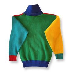 A truly charming vintage sweater in bright red, blue, teal, yellow, and green. Button on the collar, which can be worn up or folded down. Excellent vintage condition 100% acrylic Machine wash & dry or lay flat to dry Retro Winter Sweater With Color Matching, Retro Green Patchwork Sweater, Retro Color Block Sweater For Winter, Retro Color Block Winter Sweater, Retro Winter Color Block Sweater, Multicolor Fall Sweater For Playtime, Playful Multicolor Sweater For Playtime, Vintage Multicolor Color Block Sweater, Retro Green Knitted Sweater