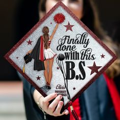 a woman holding a graduation cap that says, finally done with this bs