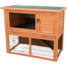 a wooden rabbit hutch with two doors and one door open