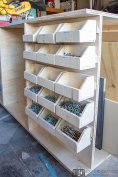 the shelves are filled with many different types of screws and nails in bins