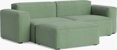 a green couch and ottoman sitting next to each other