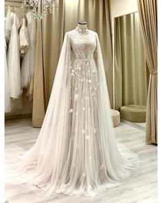 a wedding dress on display at a bridal shop in the evening, with its long veil draped over it's shoulders