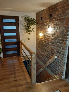 an empty room with stairs leading up to the door and lights on either side of it