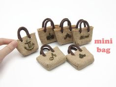 miniature bags made out of burlock and rope are shown in front of a white background