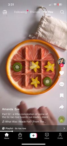 an orange plate with slices of grapefruit and kiwi fruit