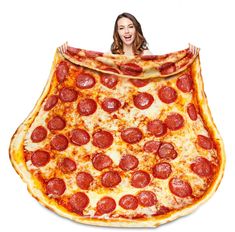 a woman is holding up a giant pepperoni pizza blanket in front of her face