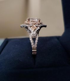 a diamond ring sitting on top of a velvet box