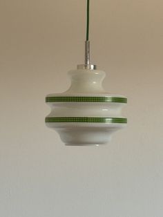 a white and green light hanging from a ceiling