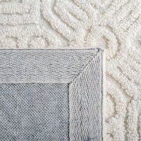 a close up view of a white and blue rug