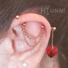 an ear with chains and a heart on it