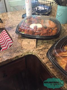 two trays of food sitting on top of a counter