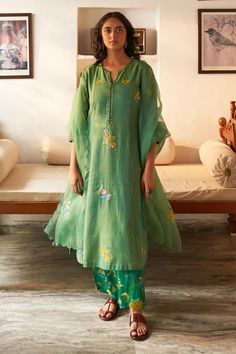 Green kurta with thread, sequin, mirror applique embroidery in floral placement pattern. Paired with floral print pant and dupatta.
Components: 3
Pattern: Embroidery
Type Of Work: Thread, sequin, mirror, floral
Neckline: Notched
Sleeve Type: Three quarter
Fabric: Mangalgiri Cotton
Color: Green
Other Details: 
Scallop bordered sheer dupatta
Side slit
Length:
Kurta Front: 46 inches
Kurta Back: 38 inches
Pant: 38 inches
Approx. product weight: 1-3 kg
Model height: 5ft 7inches, wearing size M
Occasi Chanderi Suits Design, Kurta And Palazzo, Blouse Yoke, Suit Salwar, Chanderi Suits, Personal Shopping Service, Applique Work, Kurta Set For Women, Palazzo Suit