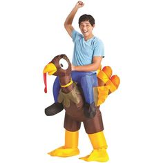 a man riding on the back of a turkey inflatable costume while wearing a blue shirt