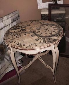 an old table with two clocks on it sitting in front of a mirror and other items