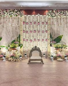 a wedding stage decorated with flowers and greenery