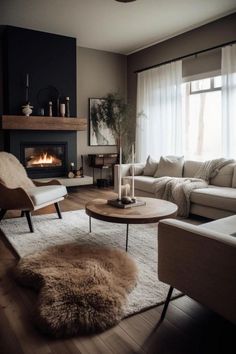 a living room filled with furniture and a fire place in the middle of the room