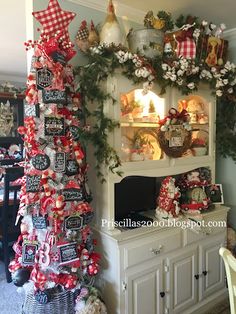 the christmas tree is decorated with red and white ribbons