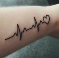 a heart and heartbeat tattoo on the arm