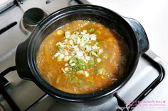 a bowl of soup sitting on top of a stove