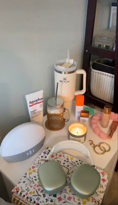 the table is covered with various items such as soaps, candles and other things