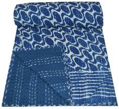 the blue and white blanket is folded on top of each other, with different patterns