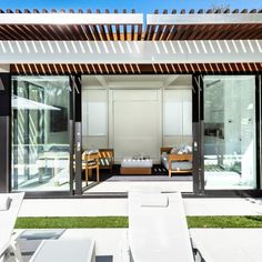 an outdoor living area with white furniture and grass