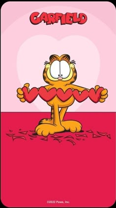 garfield the cat cartoon character holding up a heart shaped object with caption, i love garfield