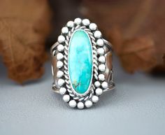 Chunky Blue Turquoise Sterling Silver Statement ring for women. This unique ring has been handmade using 925 Sterling Silver that has been fused, patina-ed then polished. The setting is a skinny oval Pilot Mountain Turquoise cabochon that is in a Bezel setting accented with twisted wire and beads. The stone is 21mm x 9mm and the tapered, wide band is 3/4" then narrows to1/8" for a comfortable fit. This ring cannot be resized, size 9.5. The holidays are right around the corner so shop early or you'll miss this one of a kind girlfriend gift or special surprise for mom, wife, sister or aunt.  Caring for your jewelry. Remove your Jewelry when pursuing outdoor sports and activities, including gardening and swimming, and when you are doing heavy house work. Avoid excessive impact against hard su Handmade Turquoise Ring For Anniversary, Handmade Turquoise Ring For Anniversary, Fine Jewelry, Artisan Turquoise Open Ring As Gift, Artisan Turquoise Open Ring For Gift, Artisan Turquoise Open Ring Gift, Handmade Turquoise Anniversary Ring In Fine Jewelry Style, Handmade Fine Jewelry Turquoise Anniversary Ring, Artisan Turquoise Open Ring, Artisan Untreated Turquoise Ring As Gift