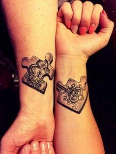 two people with matching tattoos on their arms