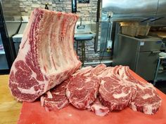 some raw meat sitting on top of a cutting board