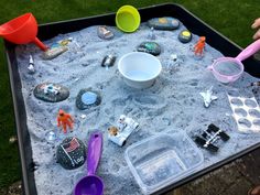 a child's play table with sand and toys