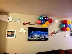 balloons and pictures are hanging on the wall