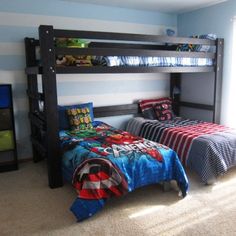 two children's beds in a bedroom with striped walls