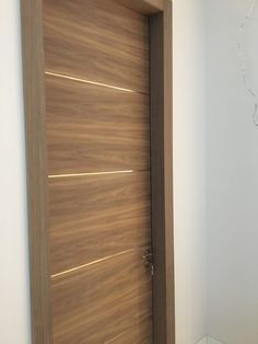 an open wooden door in a white room